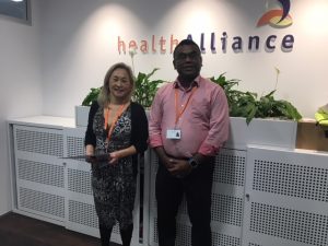 Ruby Ngan pictured here receiving her award from Prasanth Pavithran, BA Manager at healthAlliance.